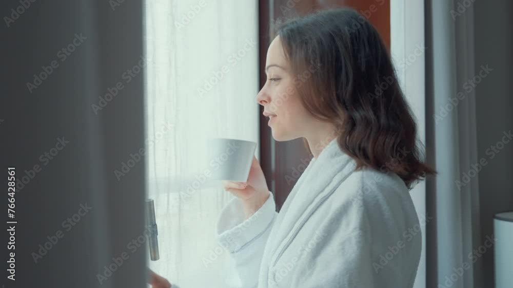 Smiling Woman Holding a Cup by Window Smiling Woman Holding a Cup by Window