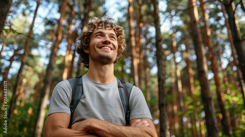 Obraz premium Smiling Man Enjoying a Sunny Day in the Forest