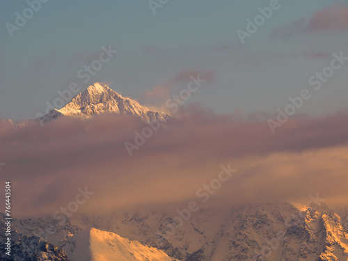 Mountains Landscape in winter. Tatra National Park- view from Czarna Gora. Mountain peaks illuminated by the rays of the setting sun shining through the clouds. Spisz. Malopolskie. Poland.