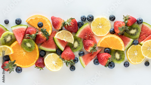 A long narrow row of fresh fruit pieces against a white background.