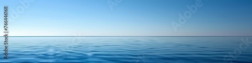 A clear blue sky over a calm sea, offering a vast expanse of water and sky for a tranquil summer backdrop with ample copy space
