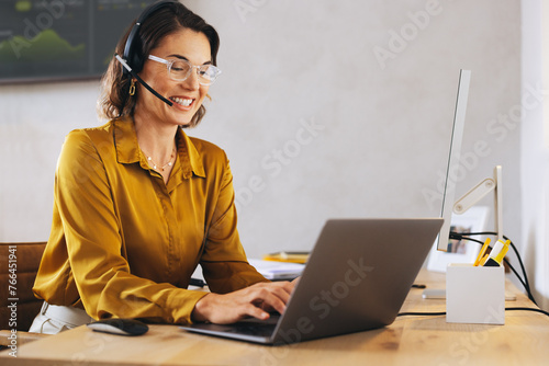 Call operator providing technical support in a telecommunications office photo