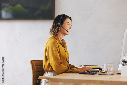 Female tech support agent managing call center operations photo