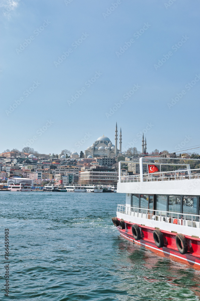 Istanbul, Turkey - March 23, 2024 - Beautiful view of the area of Eminönü in the Fatih district on the Golden Horn with Süleymaniye Mosque on a sunny day. This was on the first day of spring.
