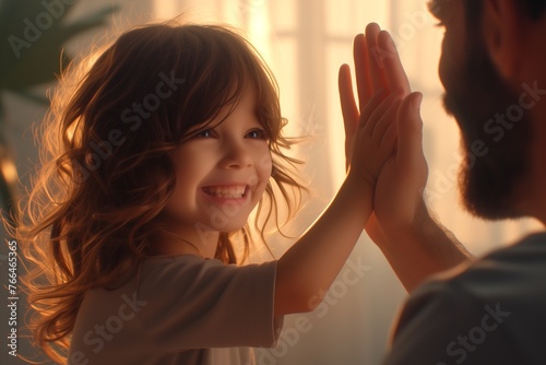 Happy cute child giving high five to male doctor