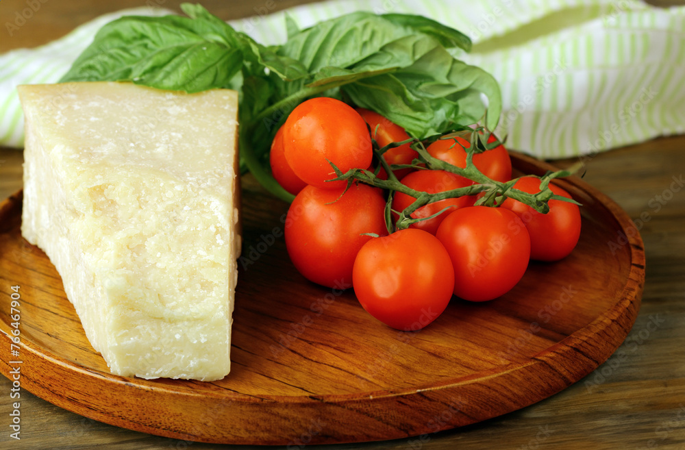 parmesan cheese with fresh basil on wooden background parmesan cheese with fresh basil on wooden background