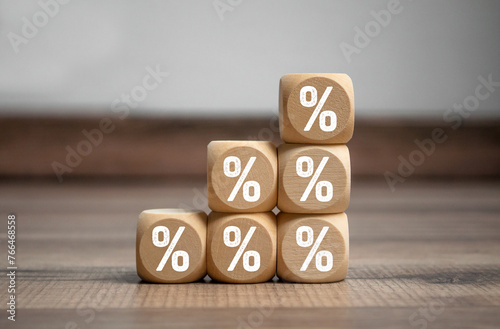 Cubes, dice or blocks with percent sign symbols on wooden background © Stockwerk-Fotodesign