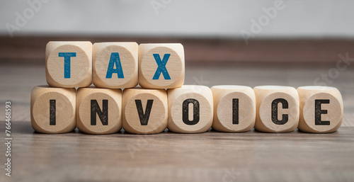 Cubes, dice or blocks with tax invoice on wooden background © Stockwerk-Fotodesign
