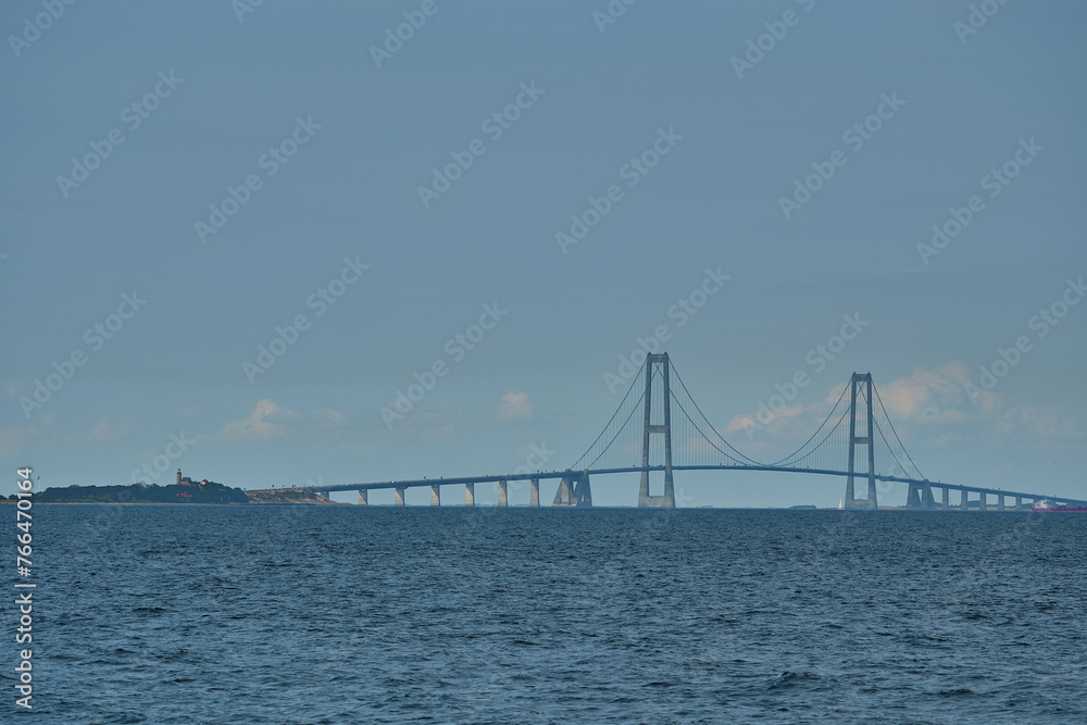 Naklejka premium great Storebelt suspension bridge connecting Denmarks islands across the baltic sea on a hazy sunny day.