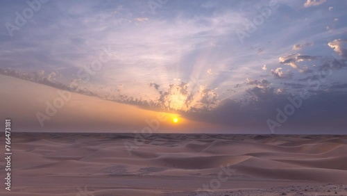 Beautiful dramatic clouds sunset sunrise time lapse over the desert sand dune of Abu Dhabi, UAE photo