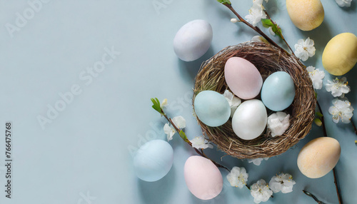 banner with easter eggs on a light blue background. Top view, flat lay with a big copy space.