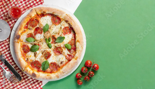 banner with pizza on a light green background. Top view, flat lay with a big copy space.