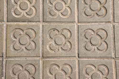 typical flower tiles by the sidewalks in Barcelona