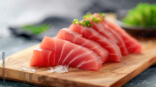 Fresh Maguro sashimi on wooden cutting board background, delicious japanese food, healthy food, ingredients for cooking. Minimal food pohtography style.