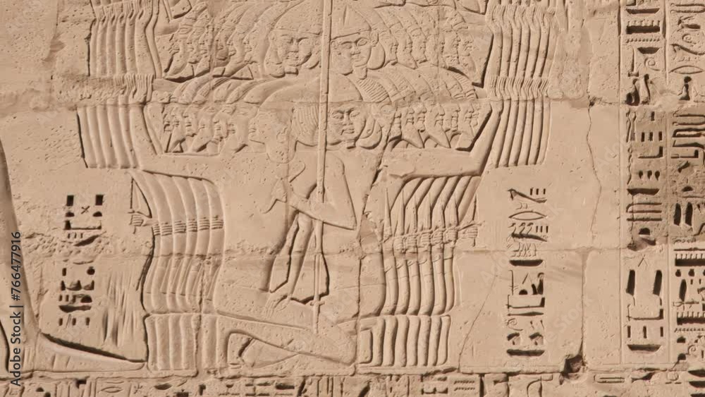 Ancient Egyptian hieroglyphs and bas-reliefs close-up in Temple of Medinet Habu. Egypt, Luxor. The Mortuary Temple of Ramesses III at Medinet Habu located in the West Bank of Luxor in Egypt. Ancient Egyptian hieroglyphs and bas-reliefs close-up in Temple of Medinet Habu. Egypt, Luxor. The Mortuary Temple of Ramesses III at Medinet Habu located in the West Bank of Luxor in Egypt.