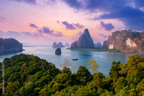 Sunset beautiful landscape of nature Thailand, Long tail boat with tourist on Hong tropical island and Phang Nga bay in turquoise sea, aerial view photo