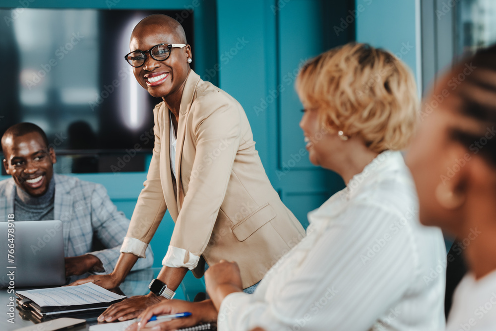 Business woman leading a successful business team in a boardroom meeting Business woman leading a successful business team in a boardroom meeting