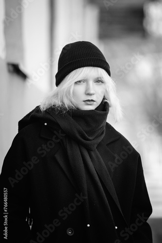 Portrait of a young beautiful blonde girl in black and white style.