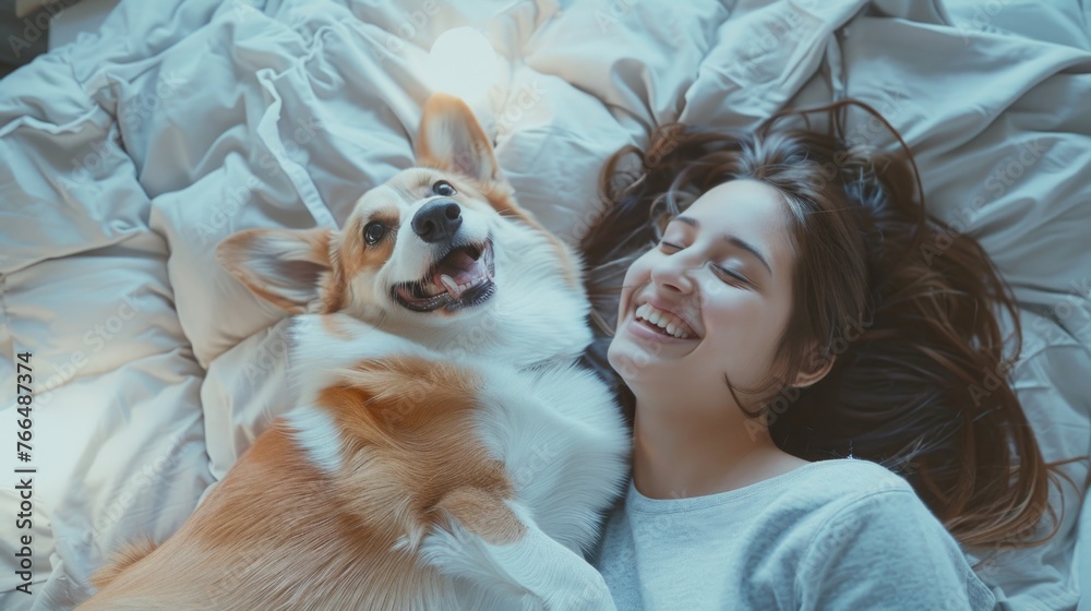 A woman laying on a bed with her dog, perfect for pet lovers