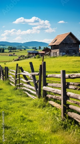idyllic rural mountain landscape with a wooden fence in the foreground