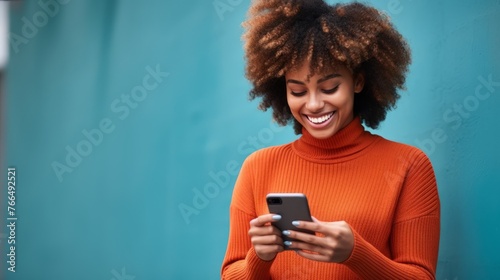 Smiling African woman using mobile phone photo