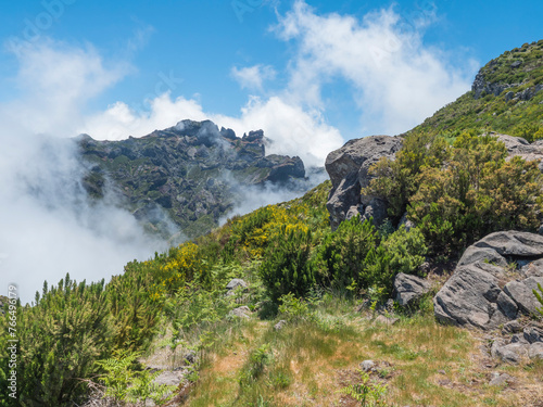View over the mountains and Atlantic Ocean above the clouds at hiking trail PR1.2 from Achada do Teixeira to Pico Ruivo, the highest peak in the Madeira, Portugal © Kristyna