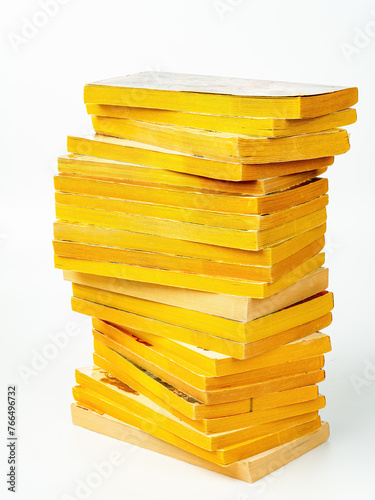 Stack of paperback books with yellow pages