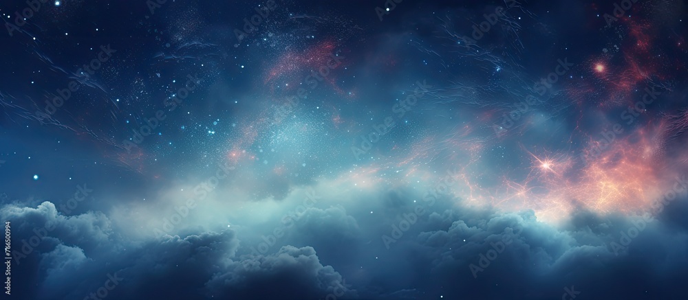 An electric blue galaxy shines in the night sky, with fluffy cumulus clouds and millions of stars decorating the horizon. A mesmerizing art in the dusk landscape of space - obrazy, fototapety, plakaty 
