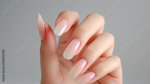 Close up Female hand with beige manicure