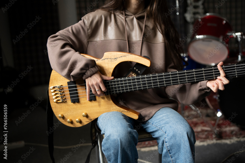 Obraz premium Young Musician Playing electric Guitar in a Studio Setting During a Rehearsal, playing accord