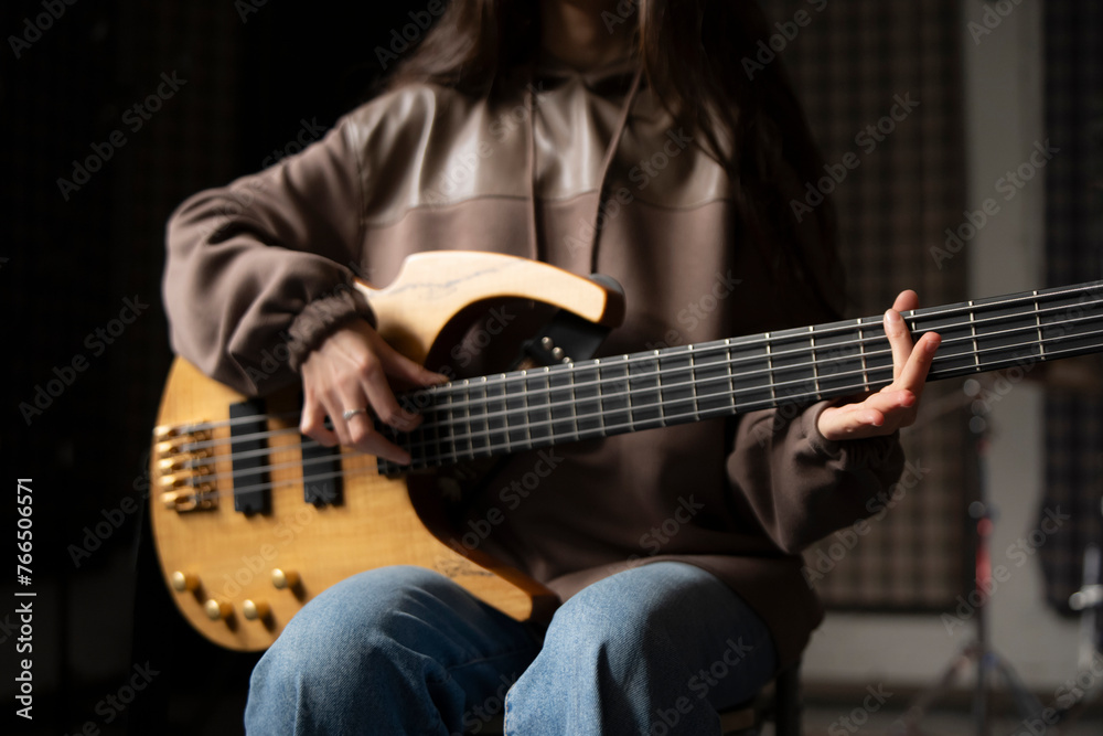 Obraz premium Young Musician Playing electric Guitar in a Studio Setting During a Rehearsal, playing accord