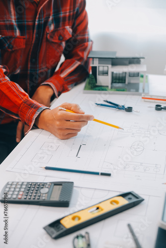 engineer people meeting working and pointing at a drawings in office for discussing. Engineering tools and construction concept.