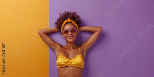 Cute sexy woman in swimsuit and sunglasses isolated on purple background. Travel, vacation, tourism concept.