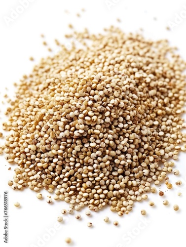 A pile of brown quinoa seeds. Concept of abundance and richness  as the quinoa seeds are piled high and spread out across the white background. The grains are small and uniform in size