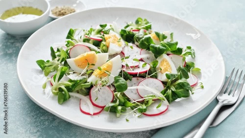 Spring radish and eggs salad. Fresh Easter salad with boiled eggs, cornsalad lettuce and radish. Stock footage video 4k photo