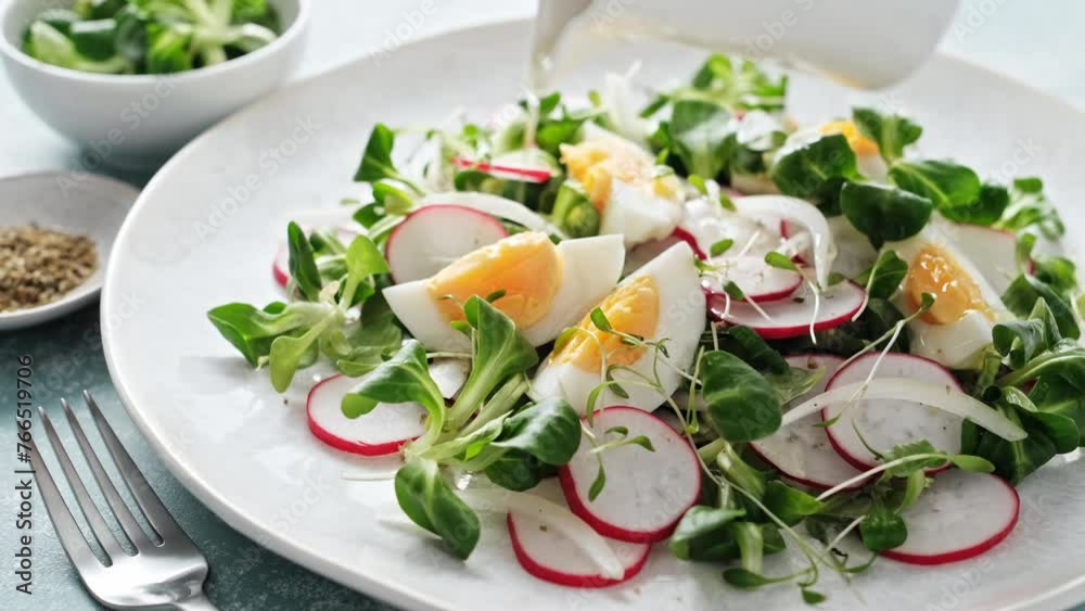 Spring radish and eggs salad. Fresh Easter salad with boiled eggs, cornsalad lettuce and radish. Stock footage video 4k