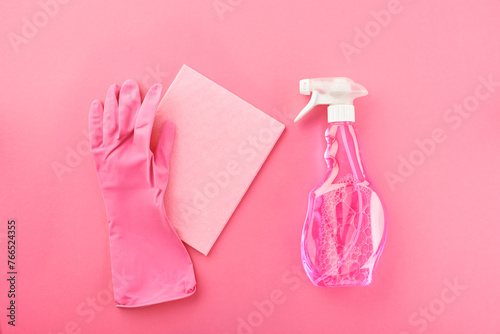 Pink glove, plastic spray bottle and rag
