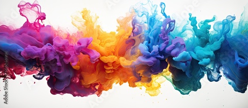 Vibrant rainbow colored ink spreading out in water creating a mesmerizing cloud of colors