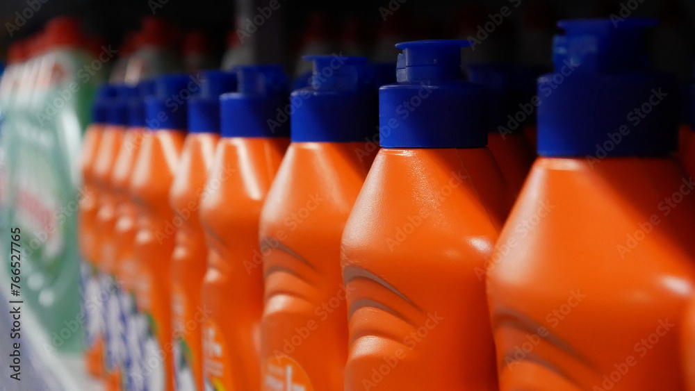 A row of dishwashing detergent bottles close-up