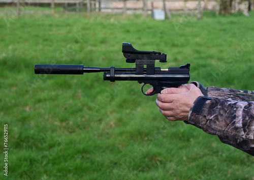 A Co2 air pistol with a red dot sight.  photo