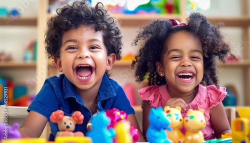Two happy multiracial children laughing while in kindergarten.  photo
