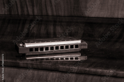 harmonica on a wooden surface photo