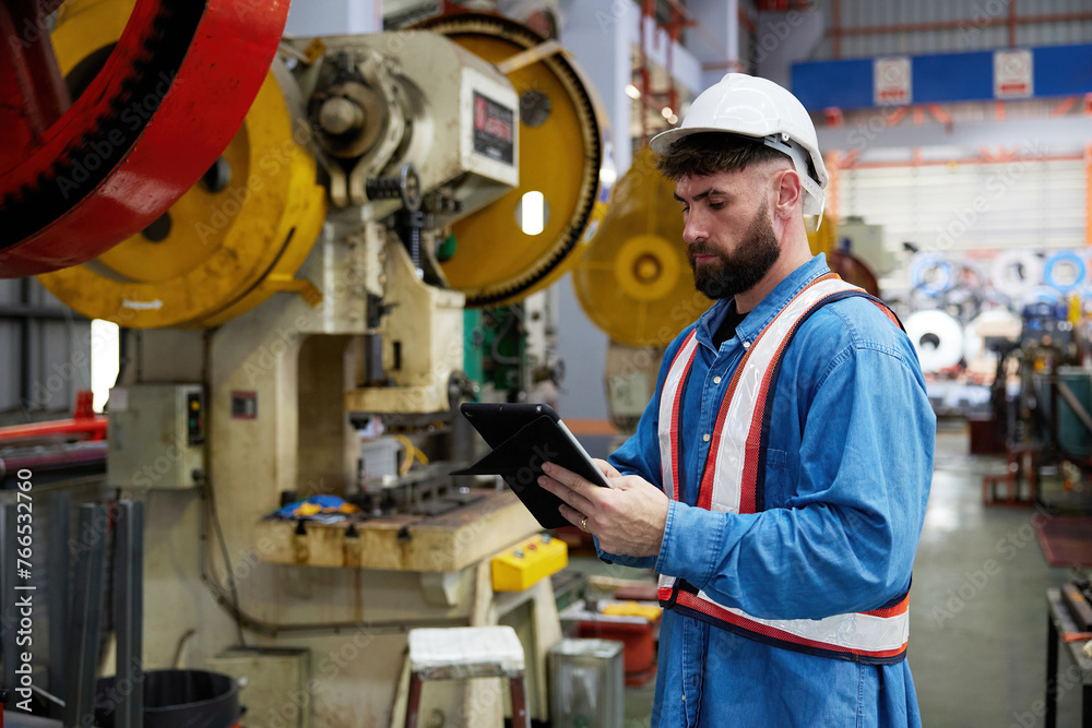 worker or engineer working on tablet and checking machine in the factory worker or engineer working on tablet and checking machine in the factory