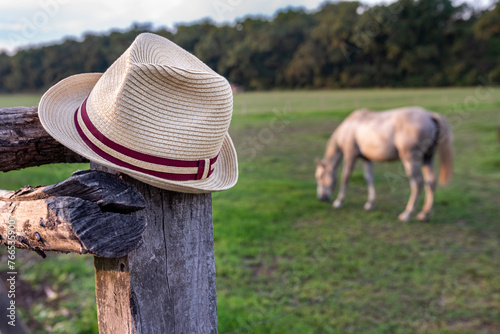 Hat on a wooden fence at a ranch