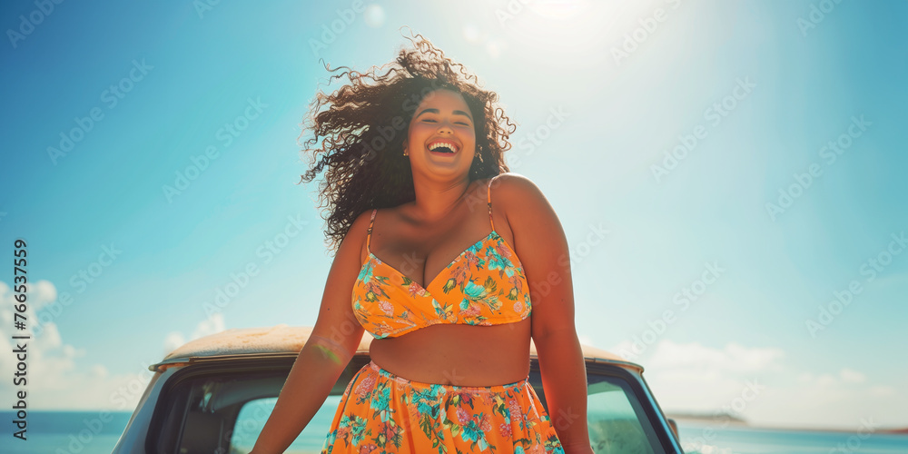 A laughing young plus-size woman on a sunlit beach with car in background radiates happiness and self-love, concepts of body positivity and self-esteem - obrazy, fototapety, plakaty 