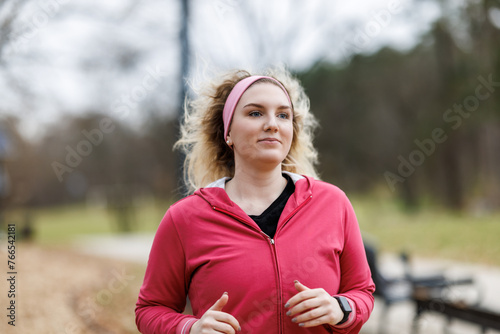 Woman in Pink Jacket Running in Park