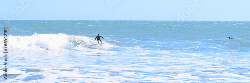 Surfer on a wave from the Beach of Pelline during summer (Maule region, Chile) photo