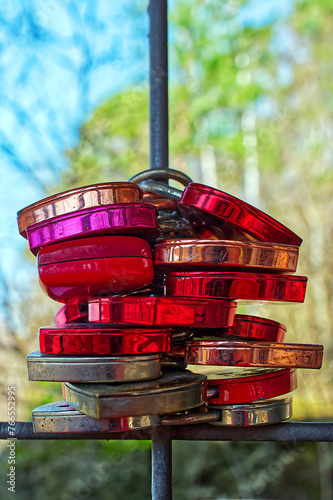 Many padlocks stacked, hanging on an iron  bar photo