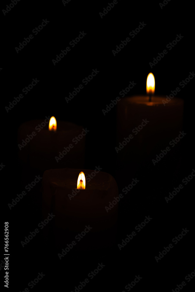 Candles, beautiful candles positioned on dark surface, black background, selective focus. Candles, beautiful candles positioned on dark surface, black background, selective focus.
