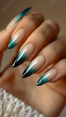Female hand with a beautiful manicure. The girl demonstrates a manicure. Emerald beige ombre.
